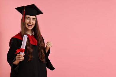 Photo of Happy student with diploma after graduation on pink background. Space for text