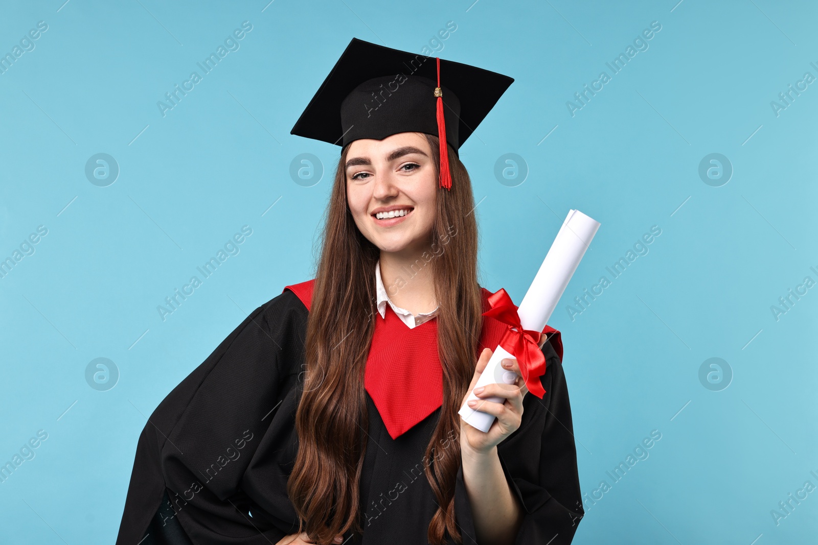 Photo of Happy student with diploma after graduation on light blue background