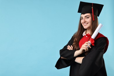 Photo of Happy student with diploma after graduation on light blue background. Space for text