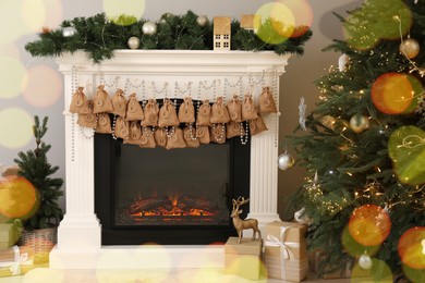 Photo of Advent calendar with gifts and decor hanging on fireplace Christmas near tree indoors