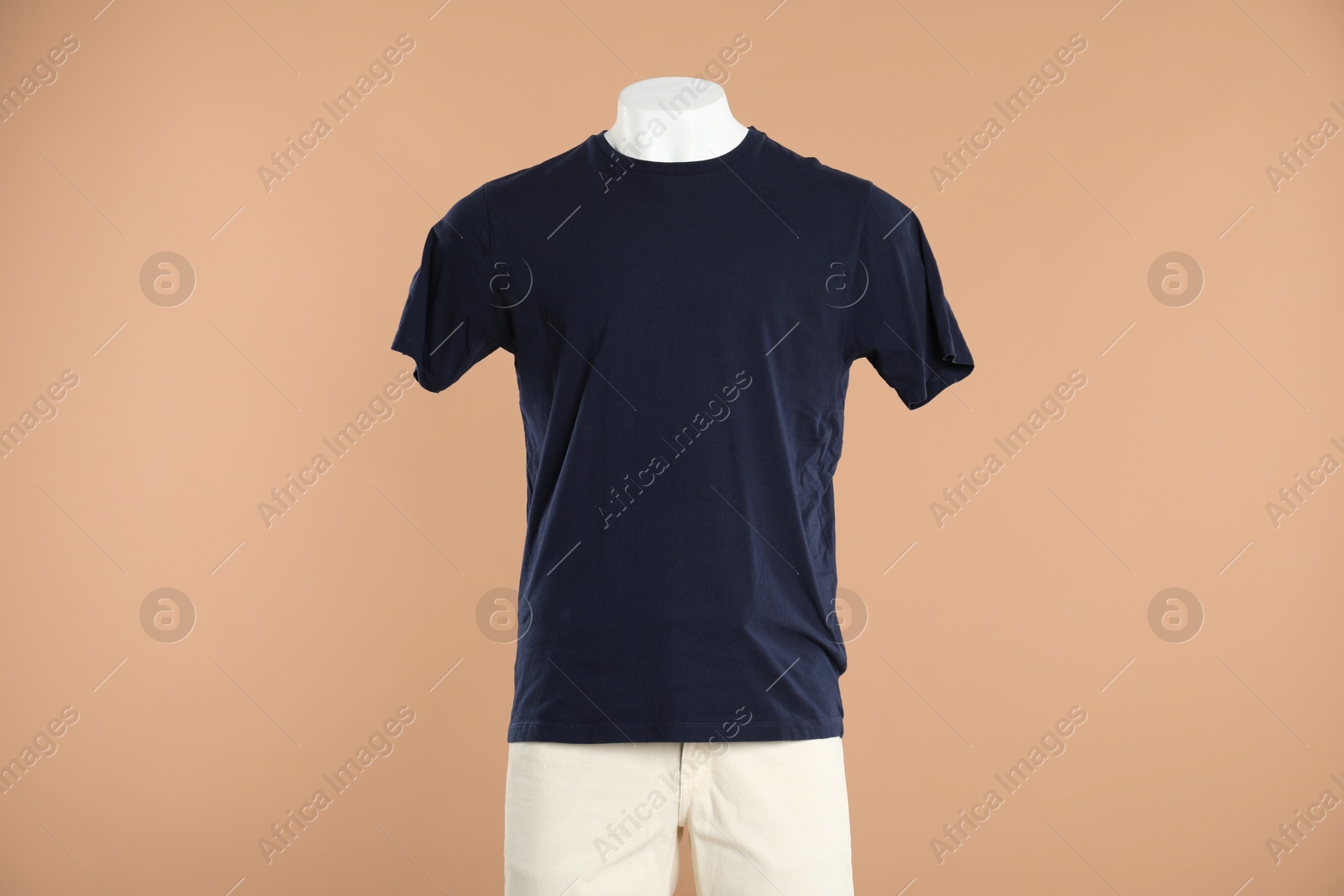 Photo of Male mannequin with stylish outfit on light brown background