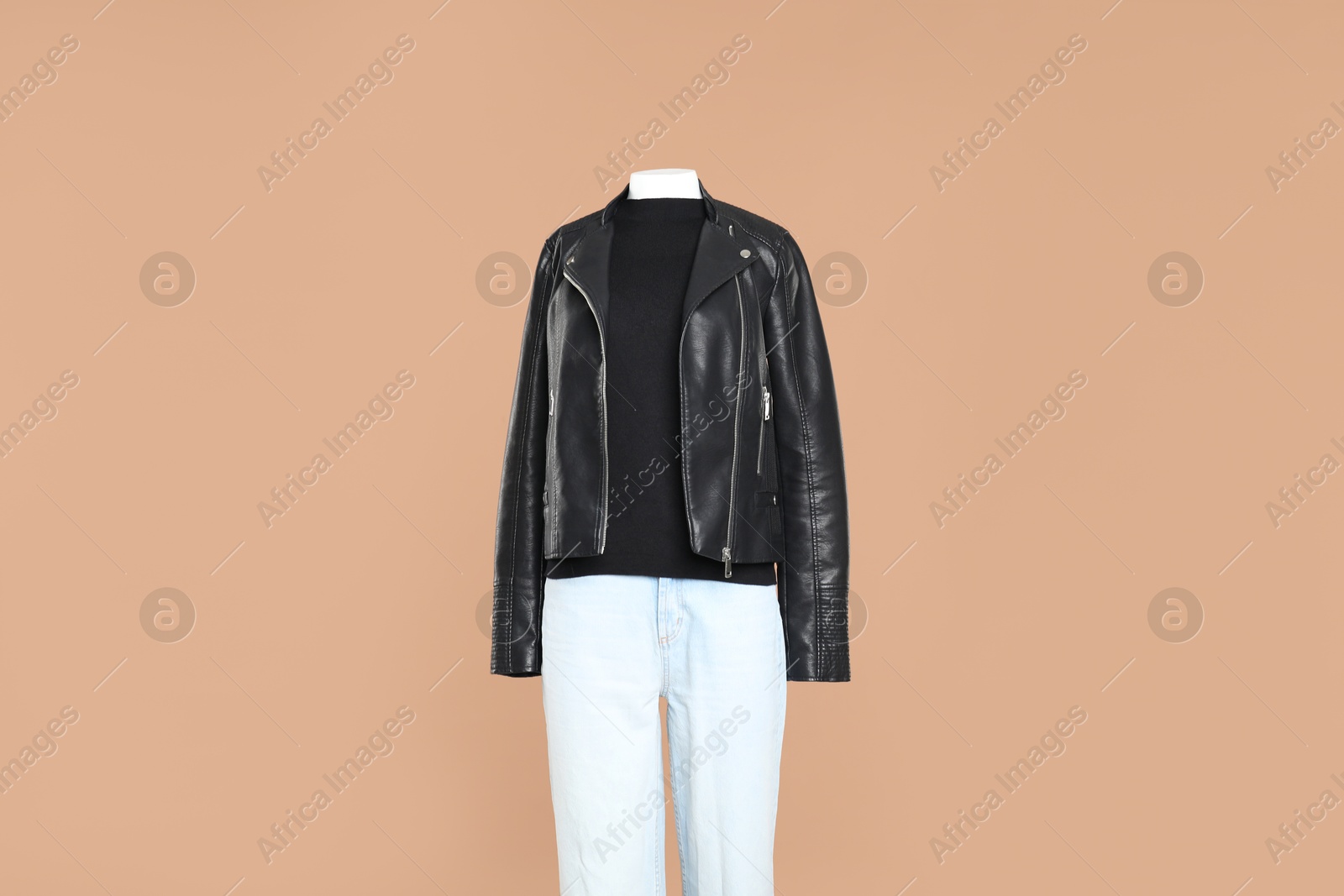 Photo of Female mannequin with stylish outfit on light brown background