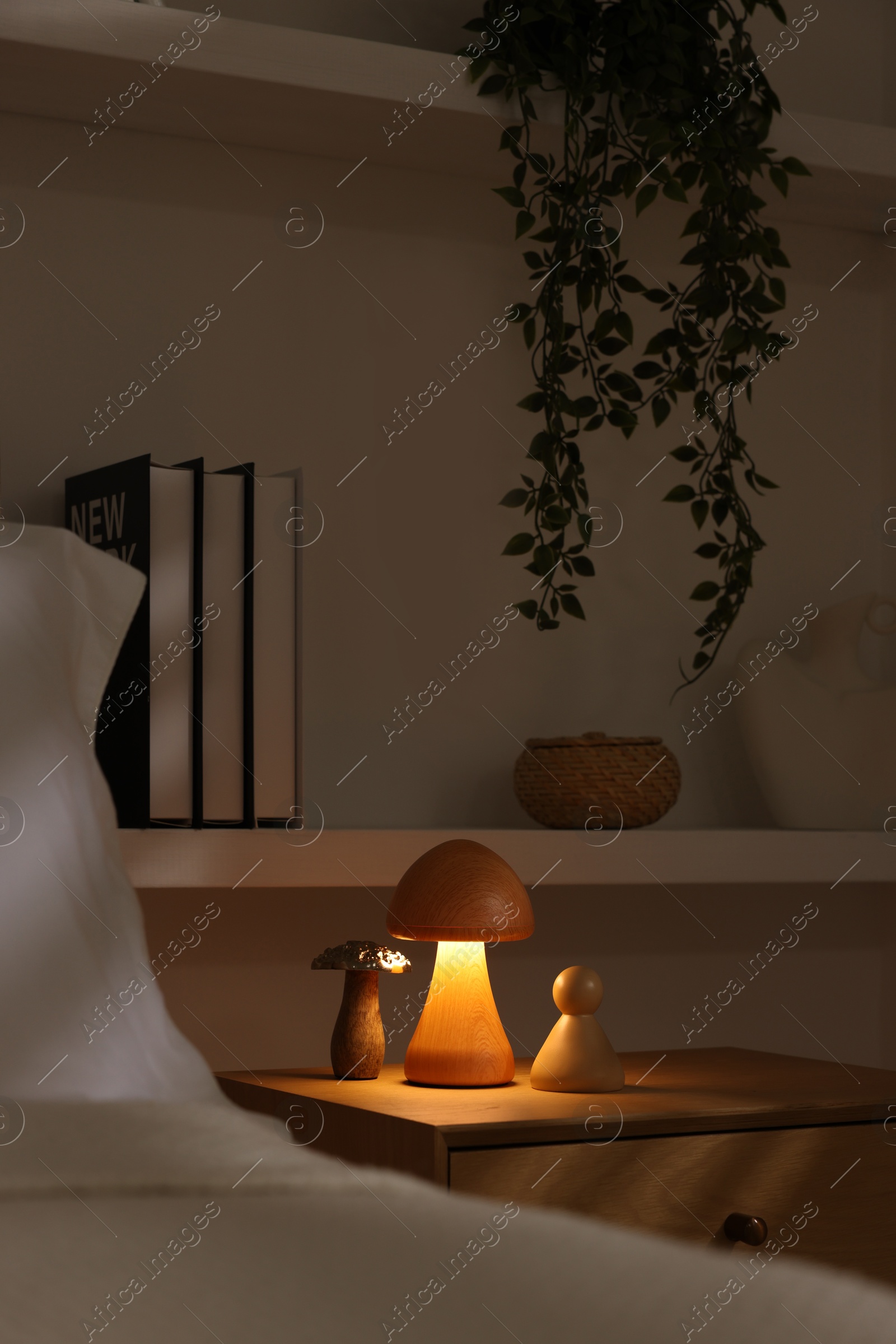 Photo of Stylish living room interior with bed, bedside table and night light