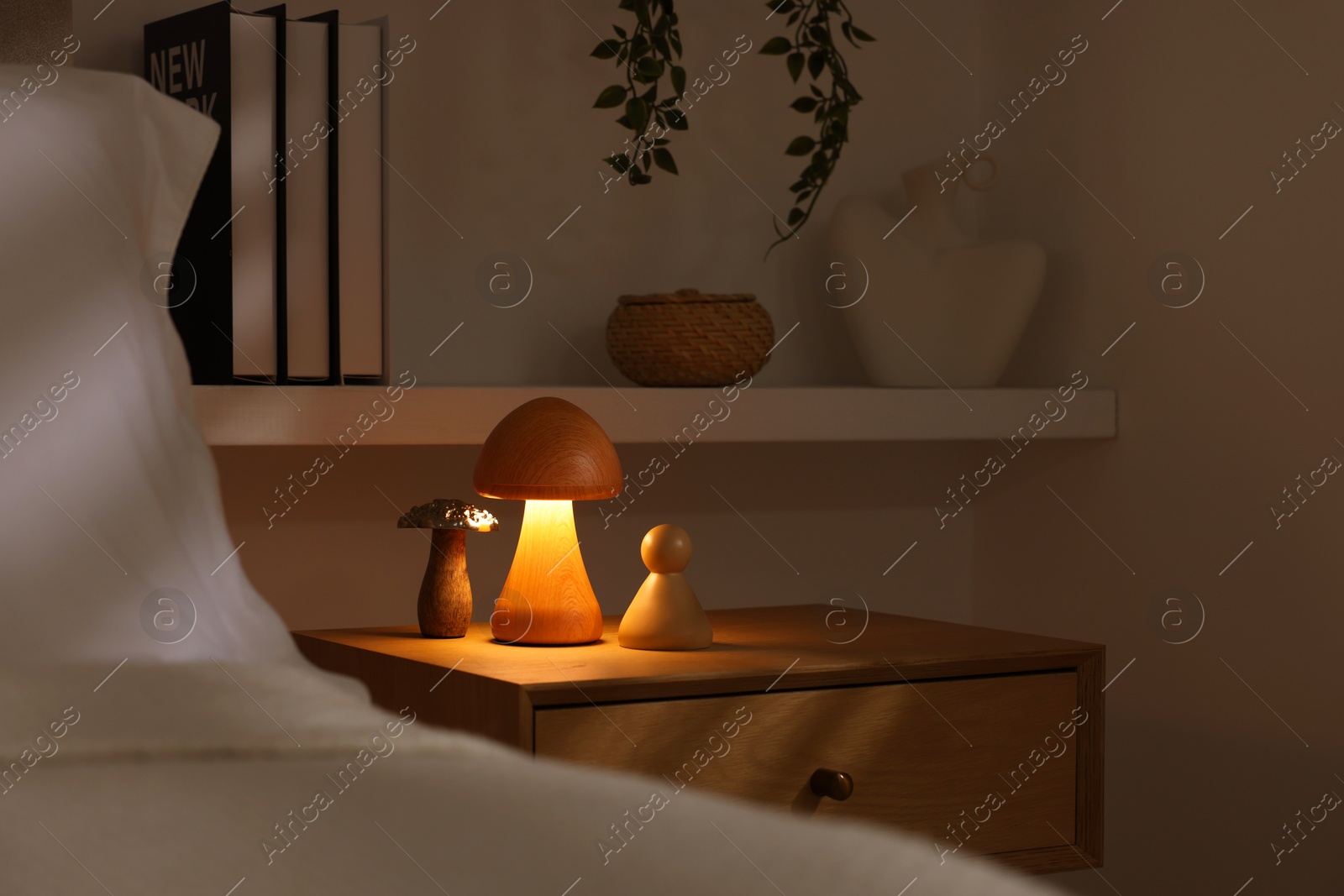 Photo of Stylish living room interior with bed, bedside table and night light