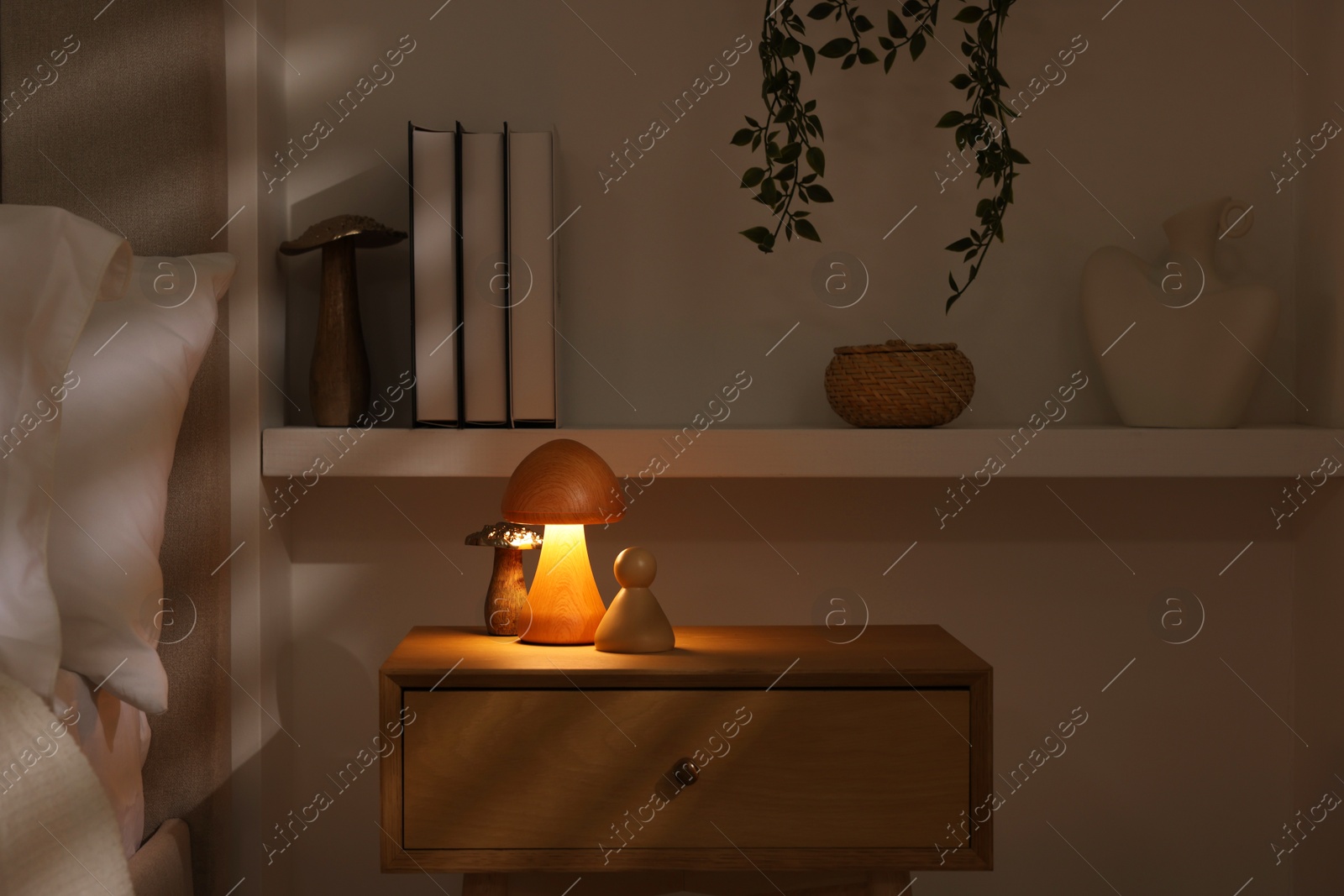 Photo of Night light on bedside table and other decor in room