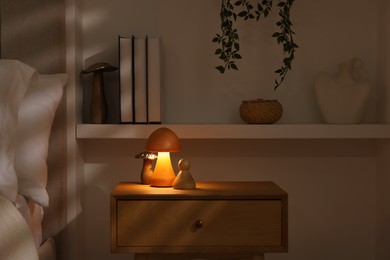 Photo of Night light on bedside table and other decor in room