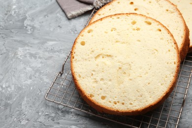 Photo of Delicious cut sponge cake on grey textured table