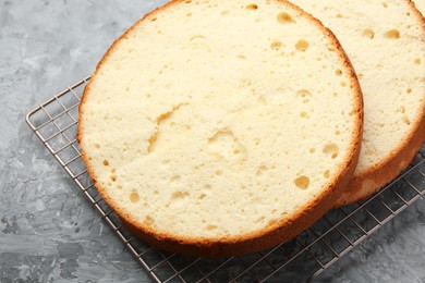 Photo of Delicious cut sponge cake on grey textured table