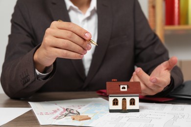 Photo of Real estate agent working at table in office, closeup