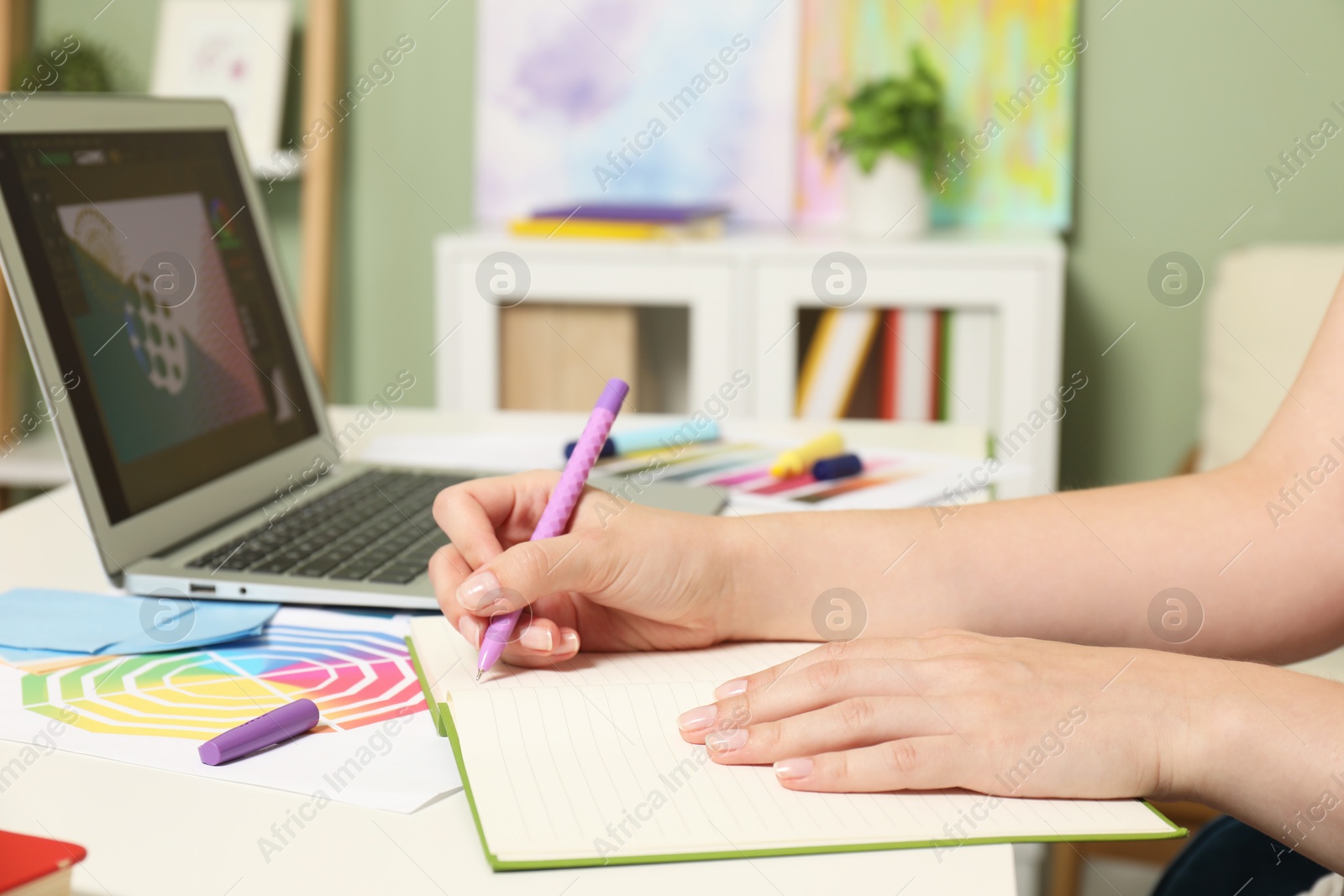 Photo of Website designer working at table indoors, closeup