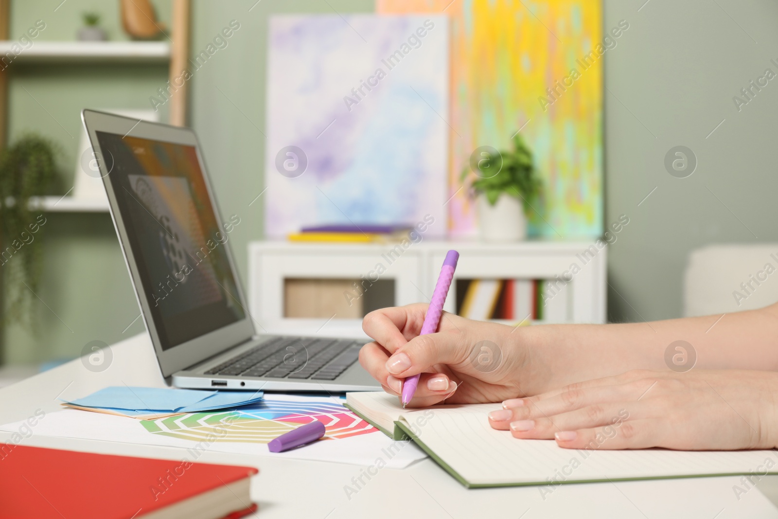 Photo of Website designer working at table indoors, closeup