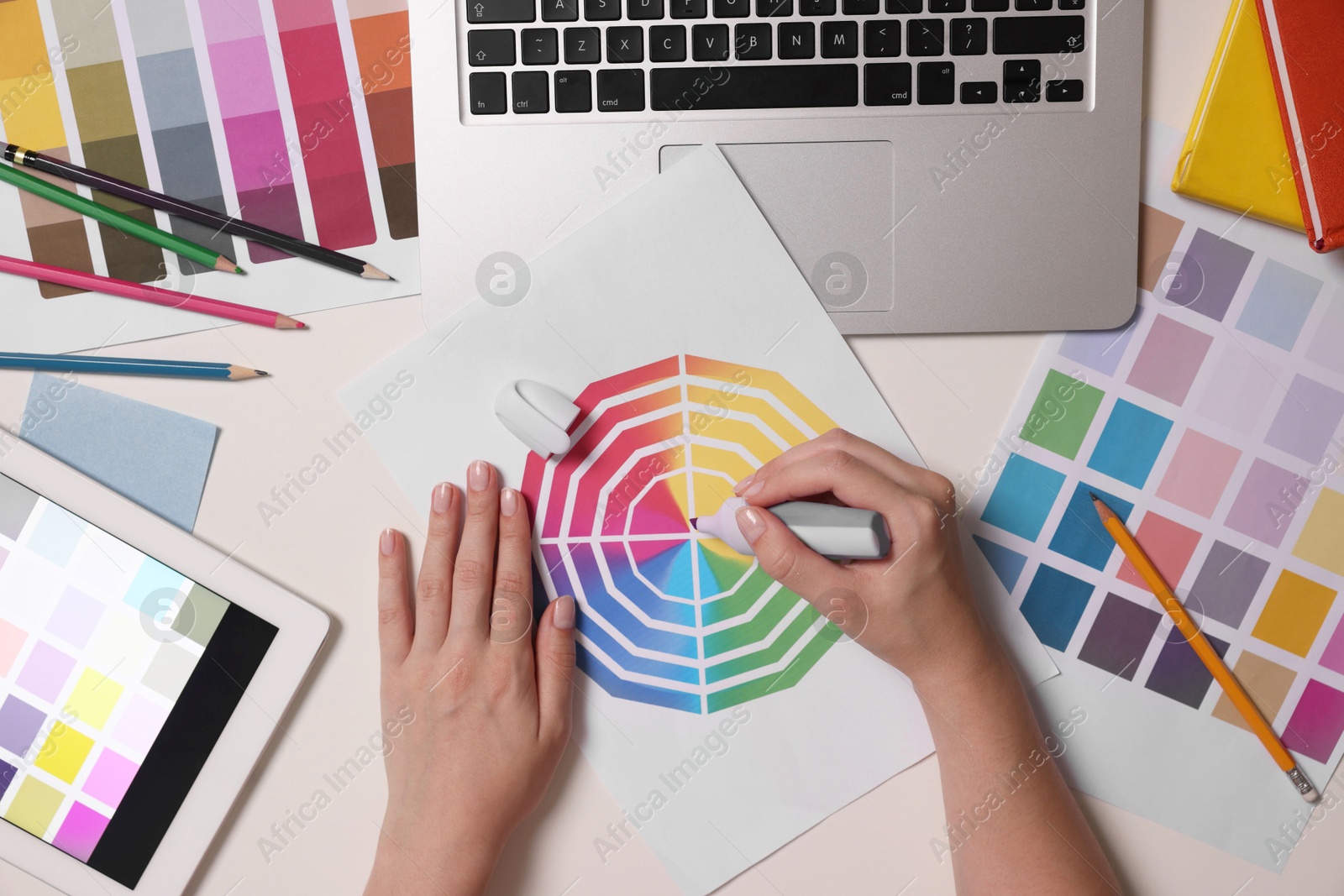 Photo of Website designer working with color palette at white table, top view