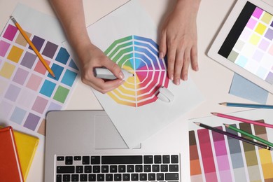 Photo of Website designer working with color palette at white table, top view