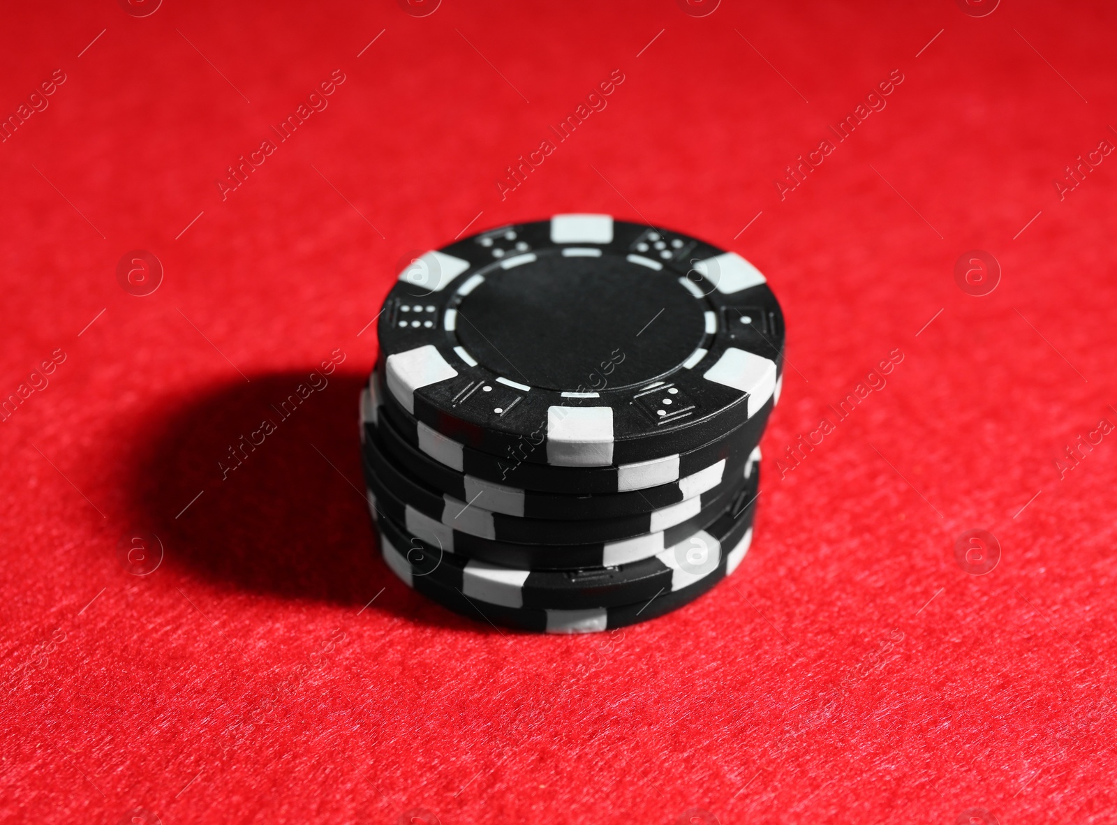 Photo of Poker game. Casino chips on red table