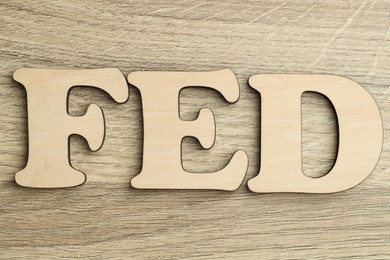 Photo of Word Fed (Federal Reserve System) made with letters on wooden table, top view