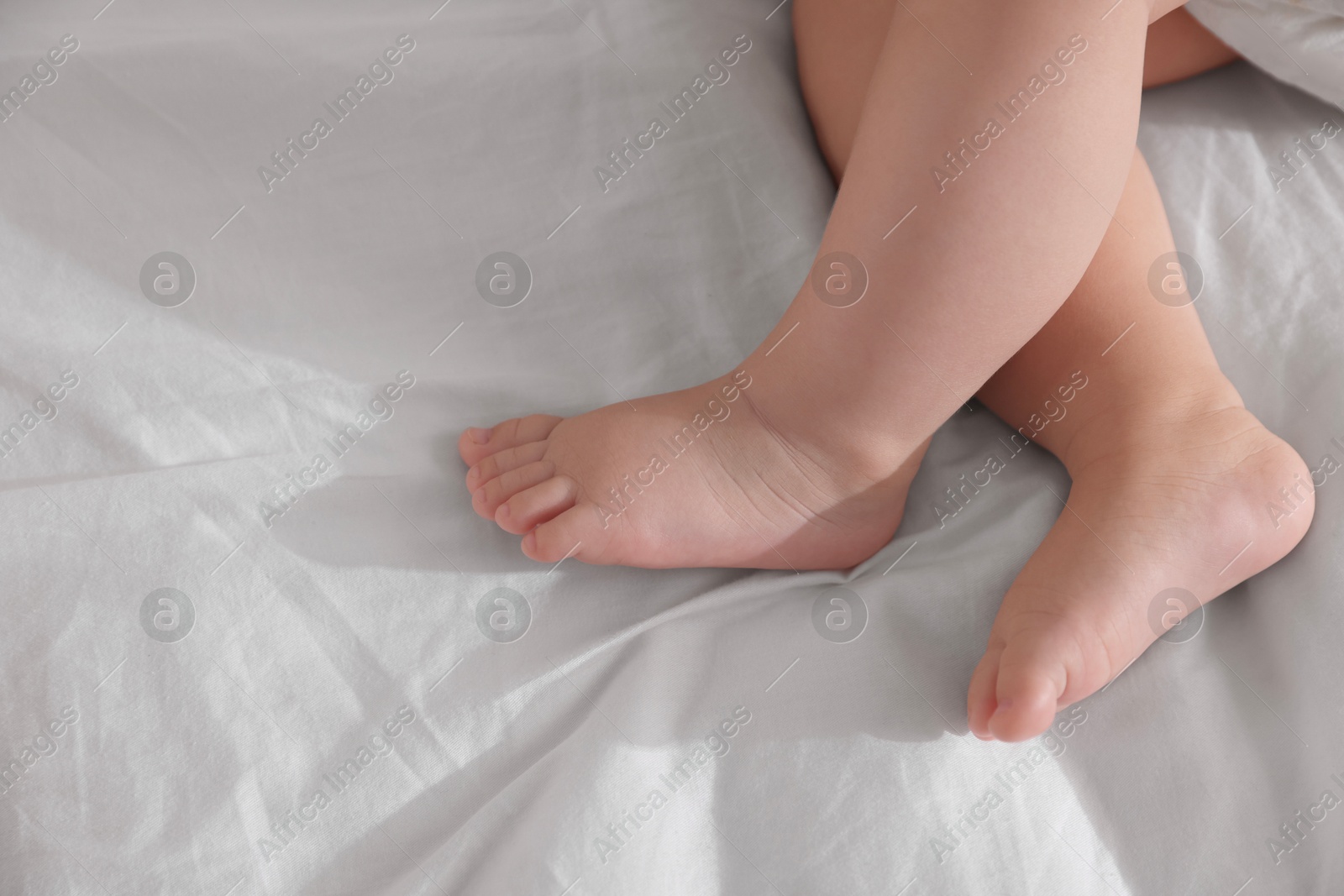 Photo of Cute little baby sleeping on bed at home, top view