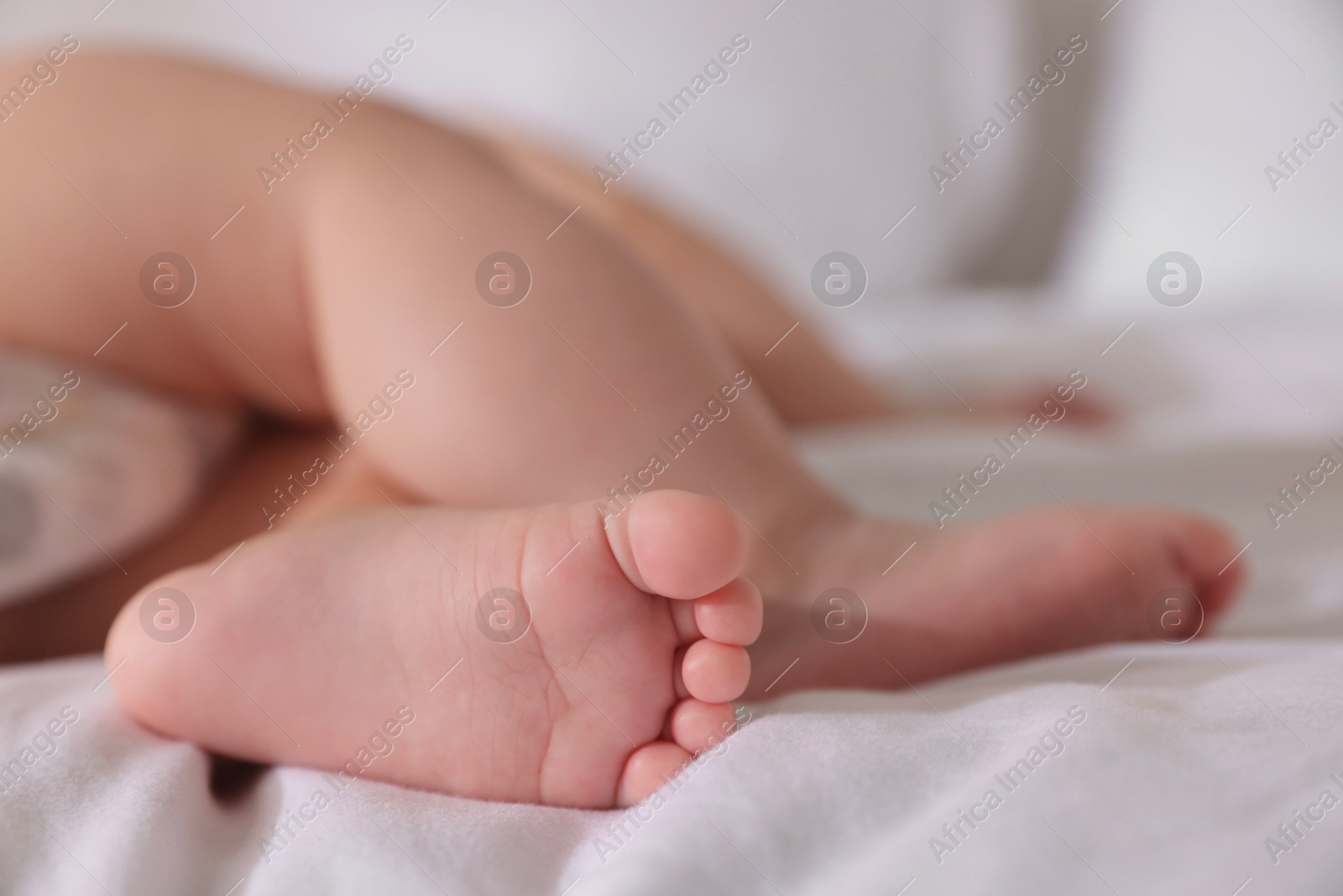 Photo of Cute little baby sleeping on bed at home, closeup