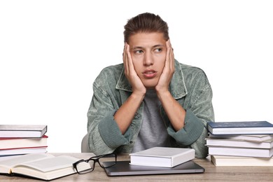 Photo of Overwhelmed student before exam at table among books against white background