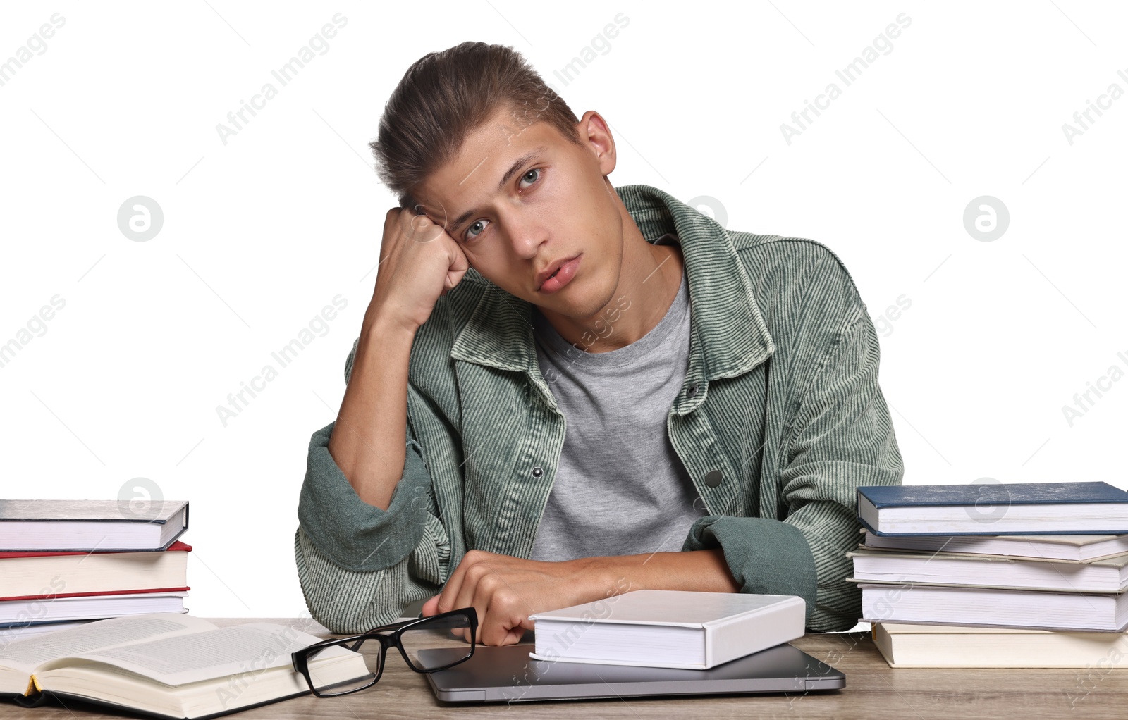 Photo of Overwhelmed student before exam at table among books against white background