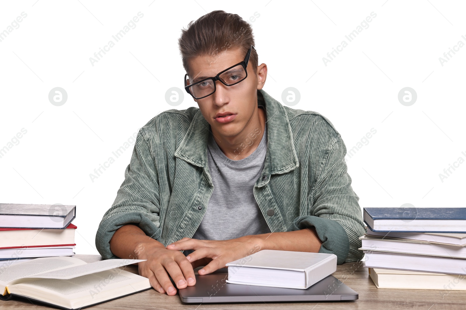 Photo of Tired student before exam at table among books against white background