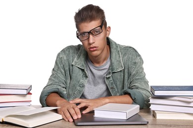 Tired student before exam at table among books against white background