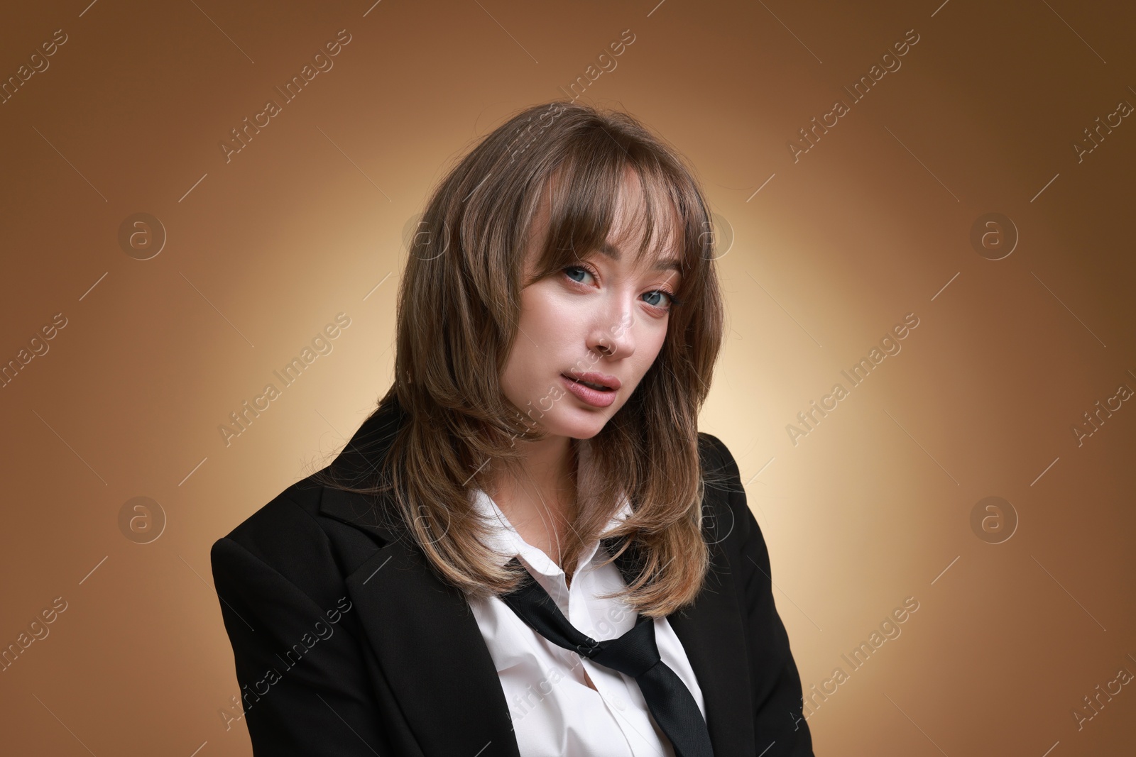 Photo of Attractive woman with stylish haircut on brown gradient background