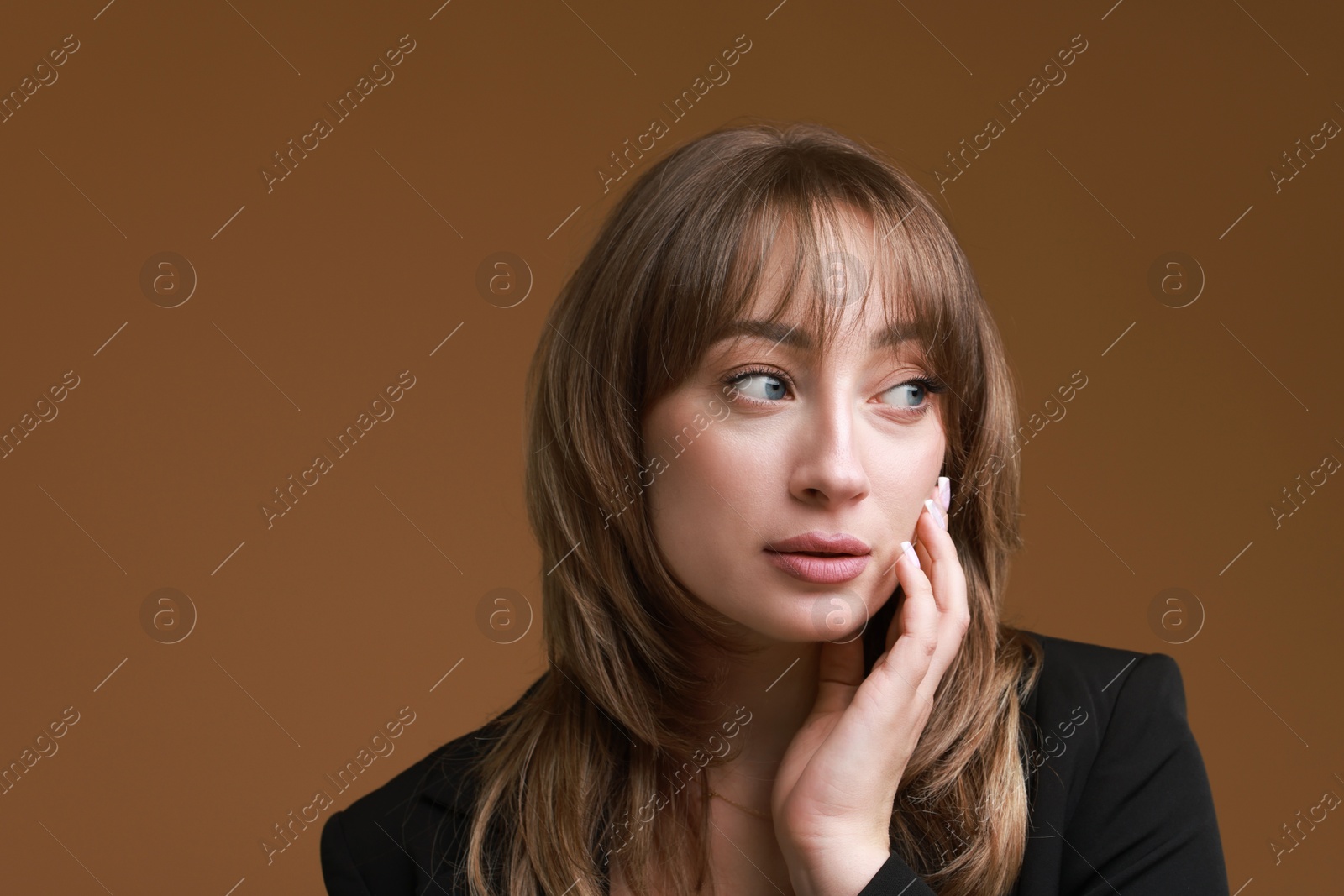 Photo of Attractive woman with stylish haircut on brown background