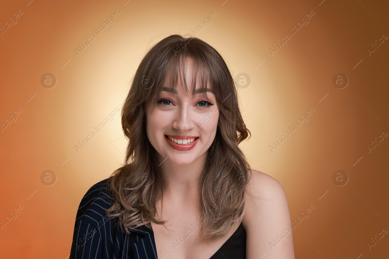 Photo of Attractive woman with stylish haircut on brown gradient background