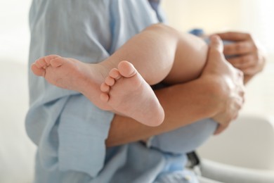 Photo of Mother with her sleeping baby indoors, closeup. Selective focus