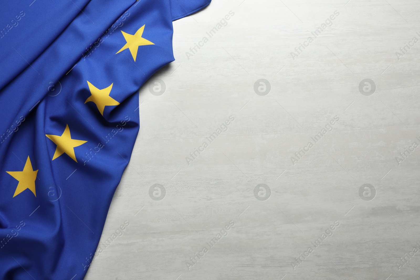 Photo of Flag of European Union on white textured background, above view. Space for text