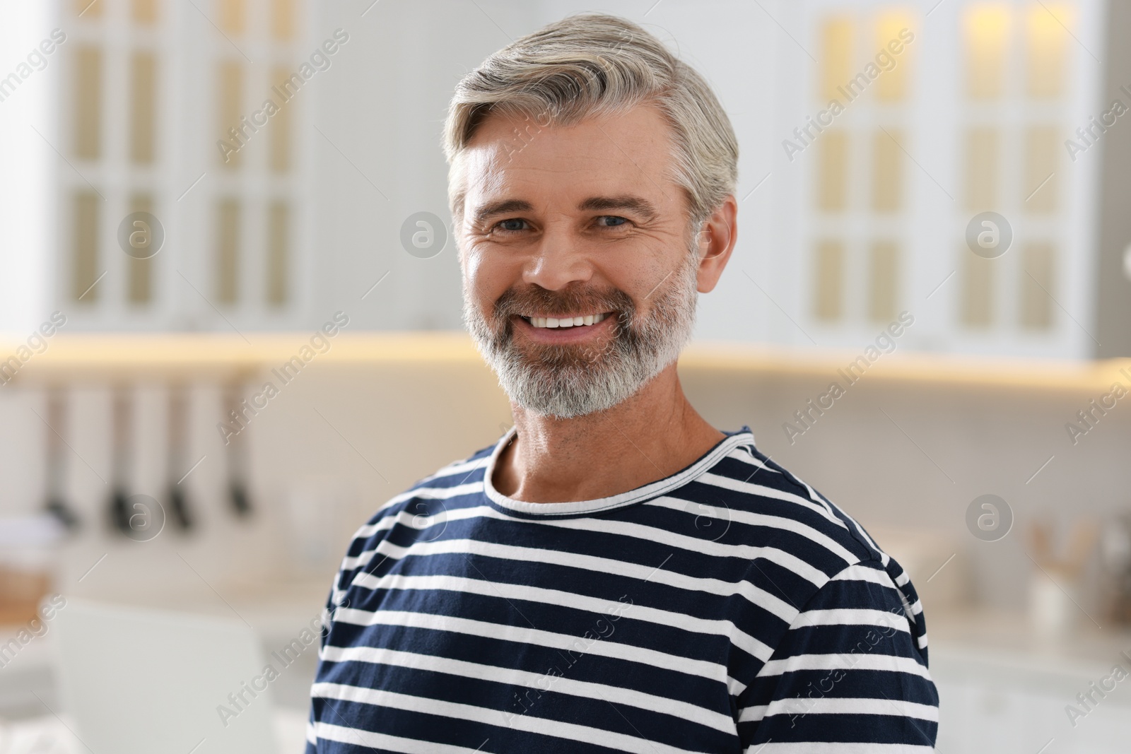 Photo of Portrait of happy middle aged man indoors