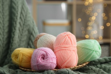 Photo of Knitting material. Skeins of soft yarn on plaid, closeup