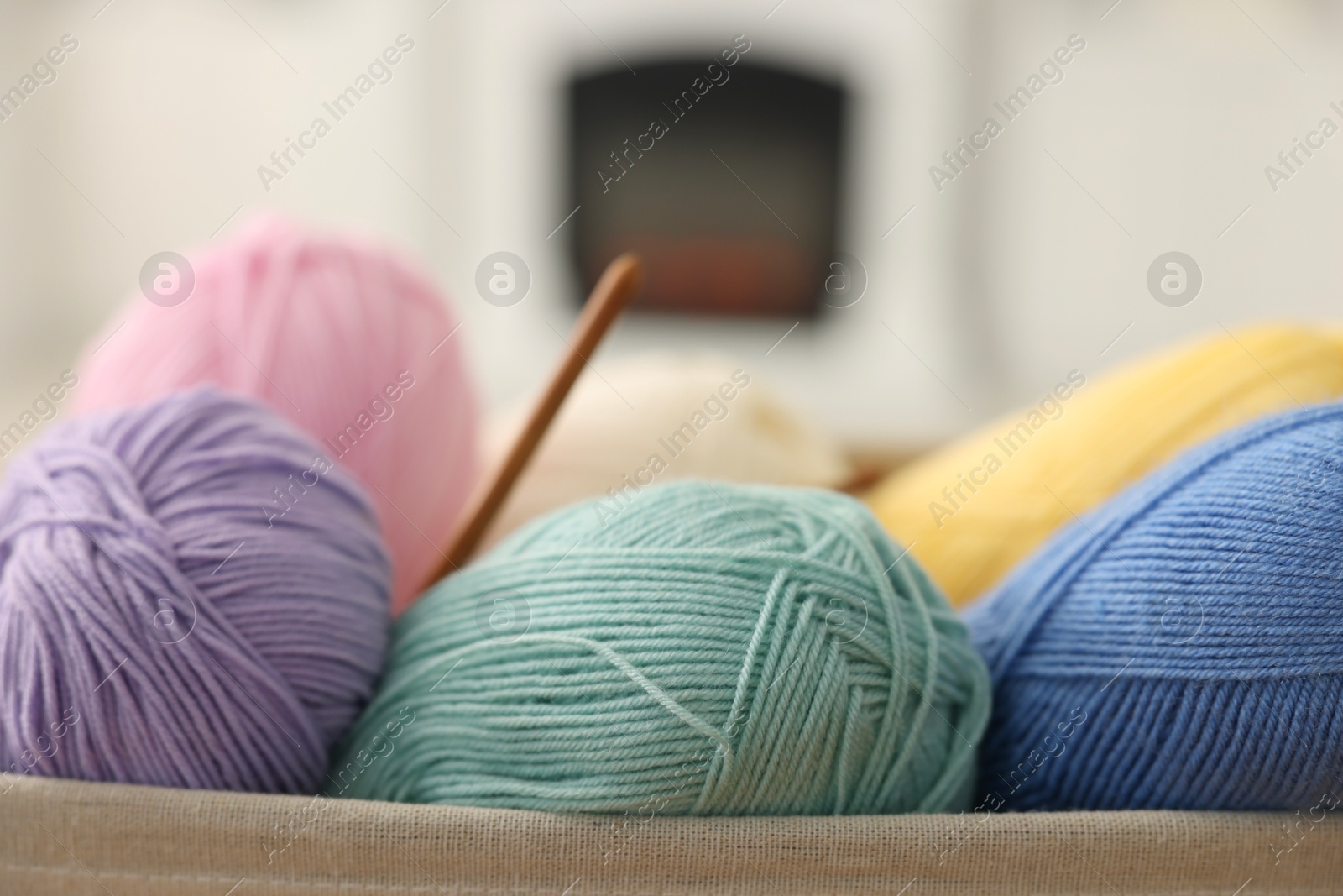 Photo of Many colorful yarns on blurred background, closeup