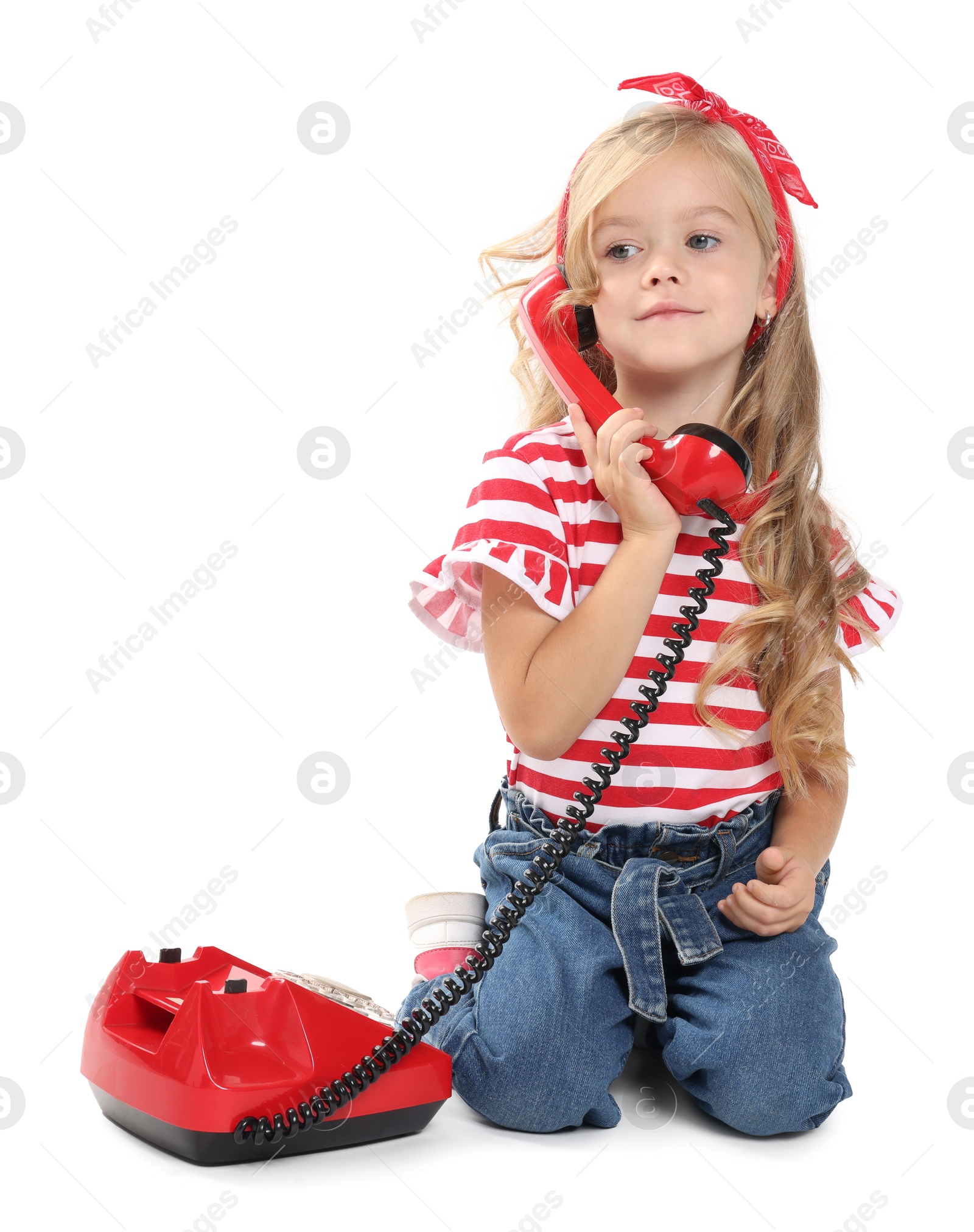 Photo of Cute little girl with telephone on white background