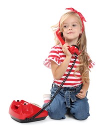 Cute little girl with telephone on white background