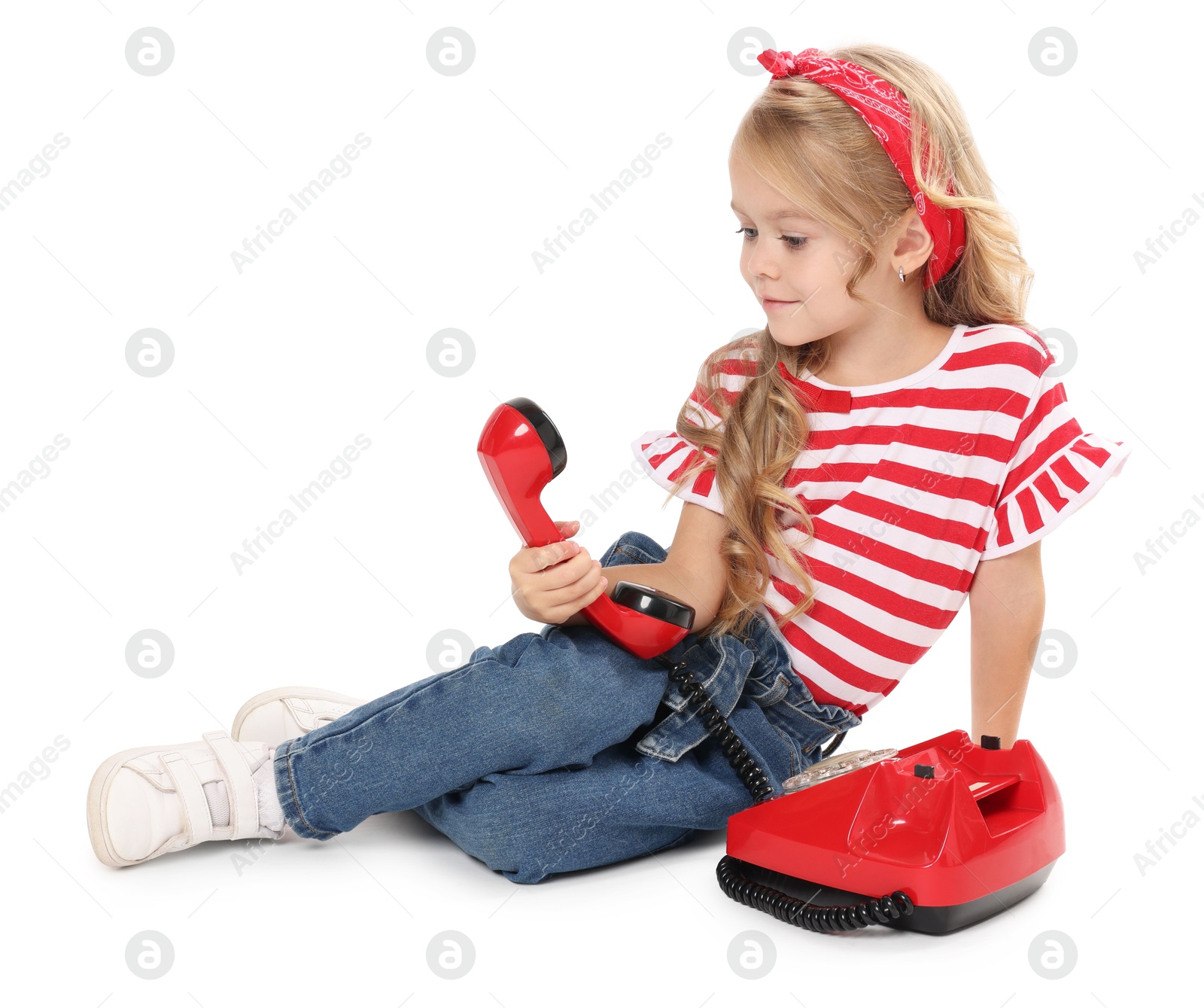 Photo of Cute little girl with telephone on white background