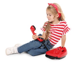 Cute little girl with telephone on white background