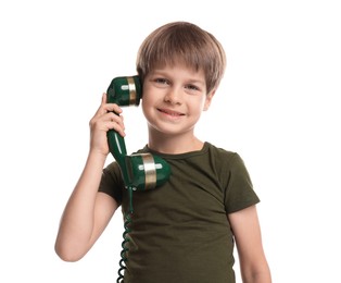 Cute little boy with handset of telephone on white background