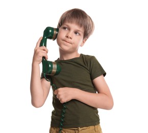 Cute little boy with handset of telephone on white background