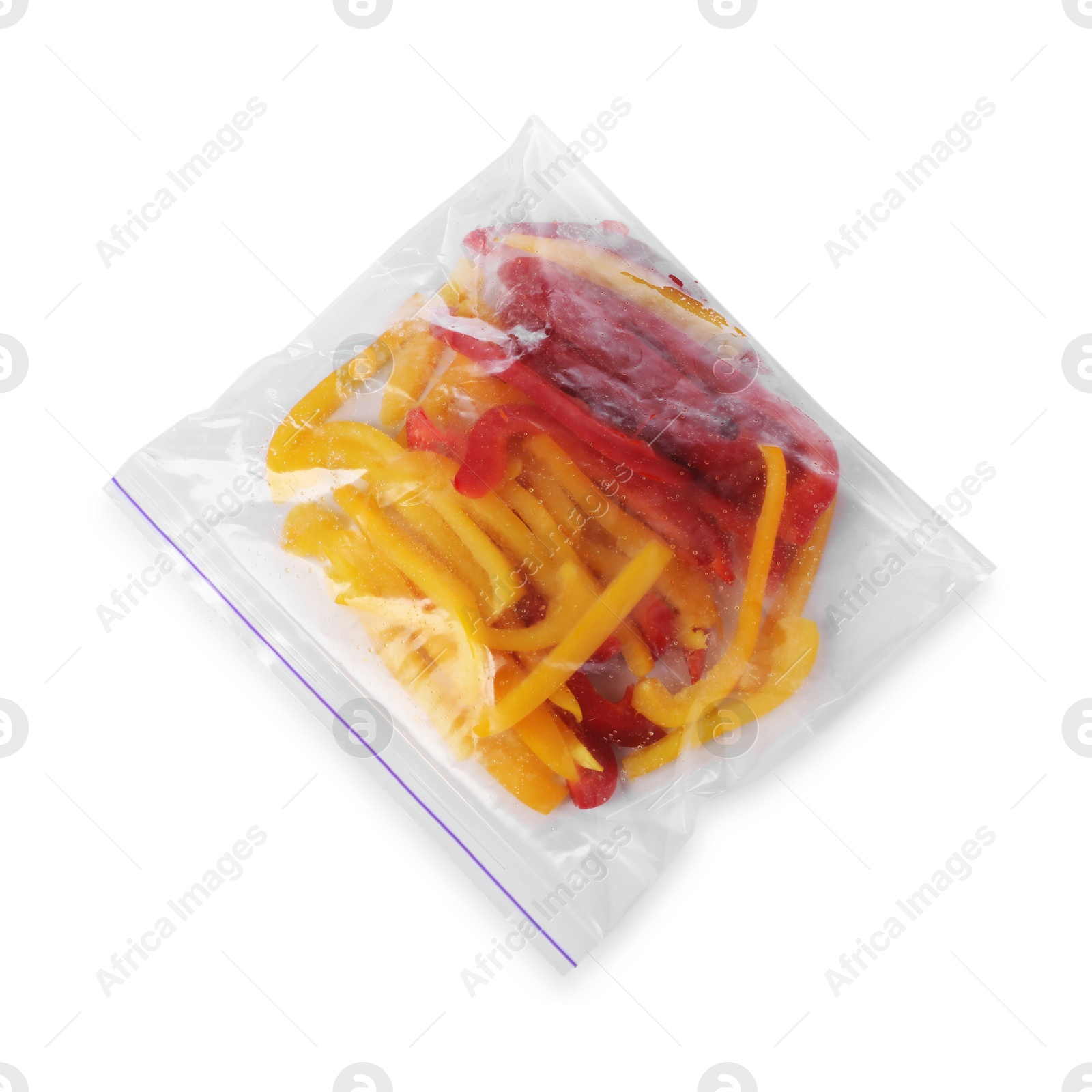 Photo of Pieces of frozen bell peppers in plastic bag isolated on white, top view