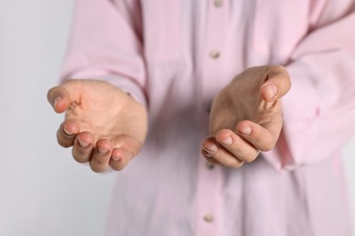 Photo of Man holding something on light background, closeup