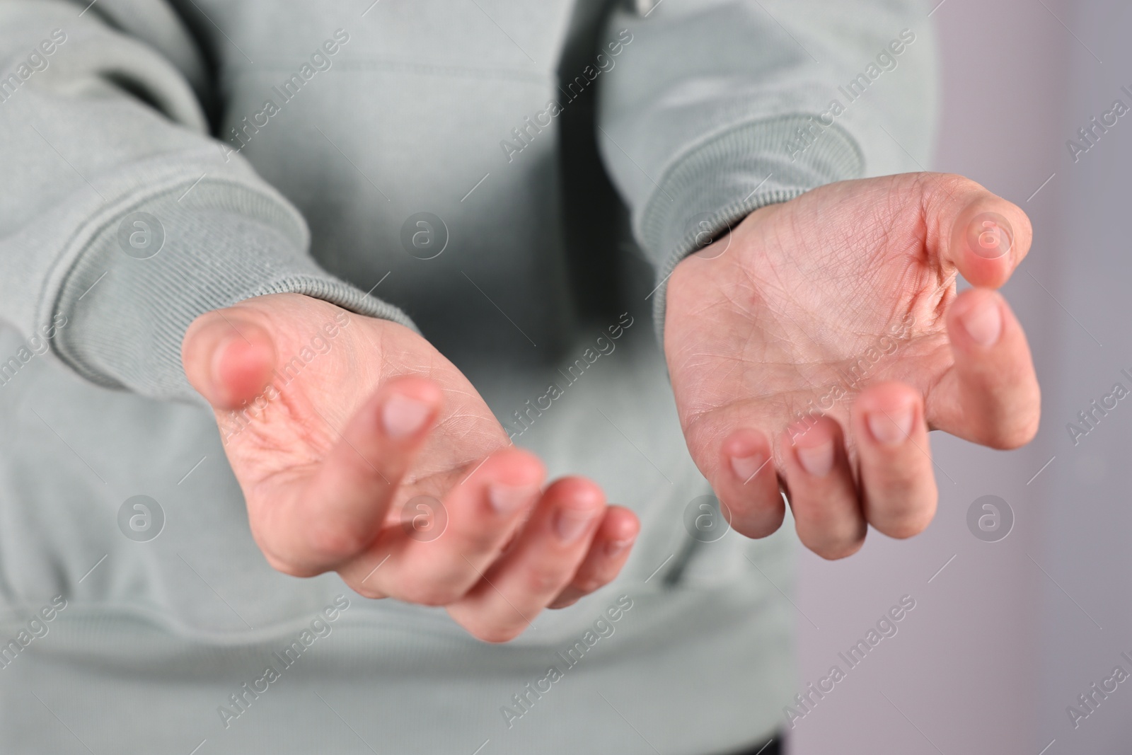 Photo of Man holding something on light background, closeup