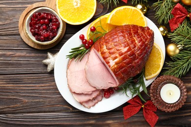 Photo of Christmas food. Tasty baked ham served on wooden table, flat lay