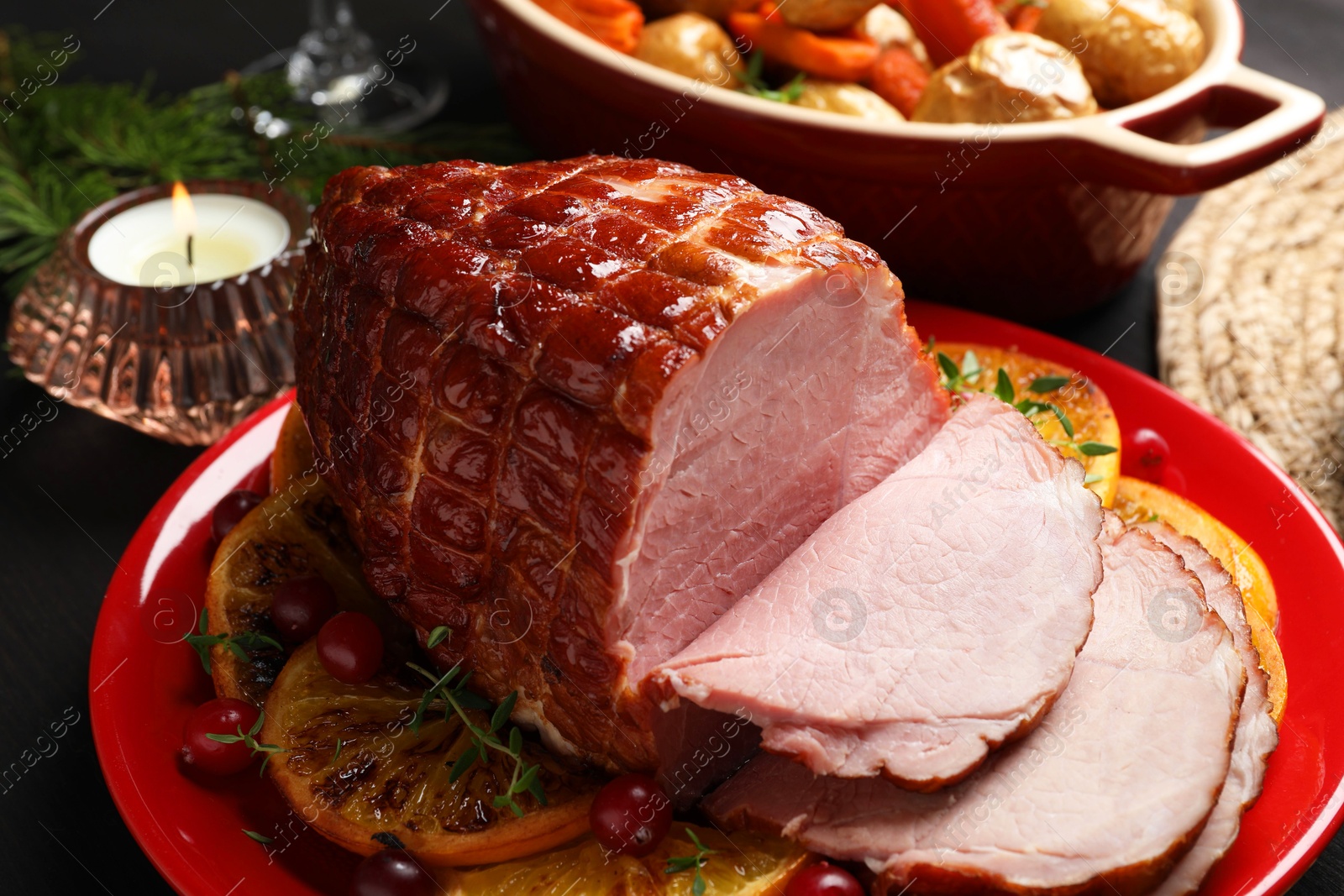 Photo of Tasty baked ham served on black wooden table, closeup