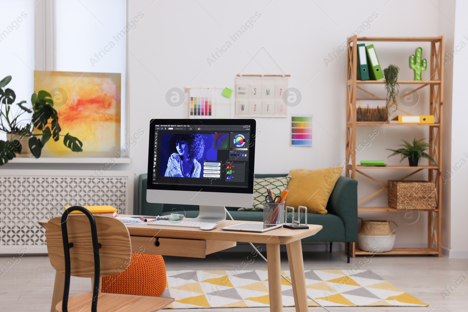 Photo of Designer's workplace with computer and stationery on wooden table indoors