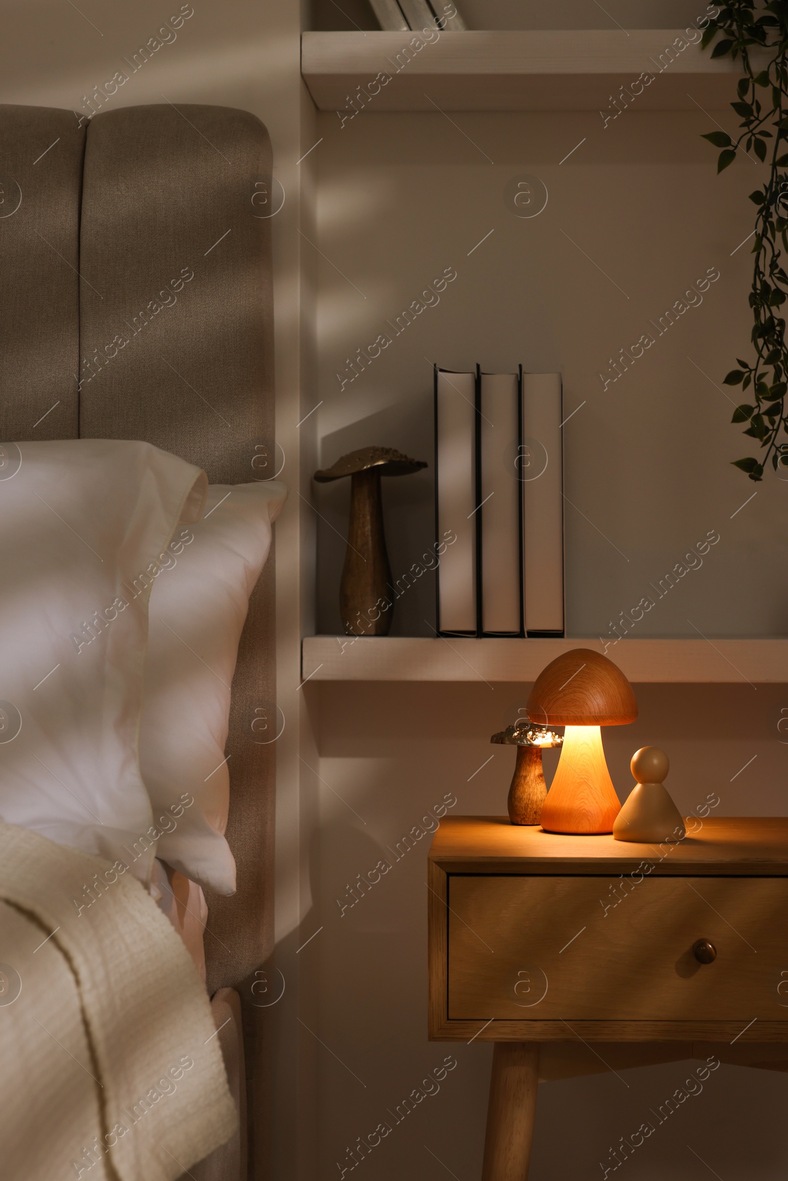 Photo of Stylish living room interior with bed, bedside table and night light