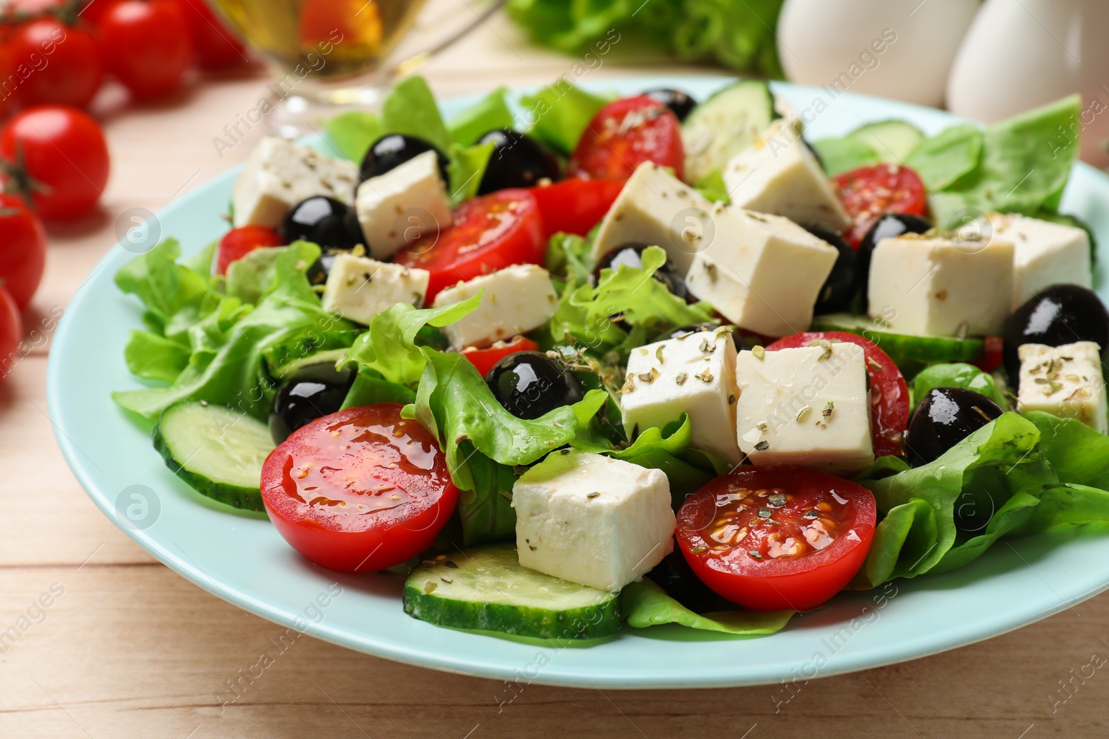 Photo of Delicious salad with feta cheese served on white wooden table, closeup