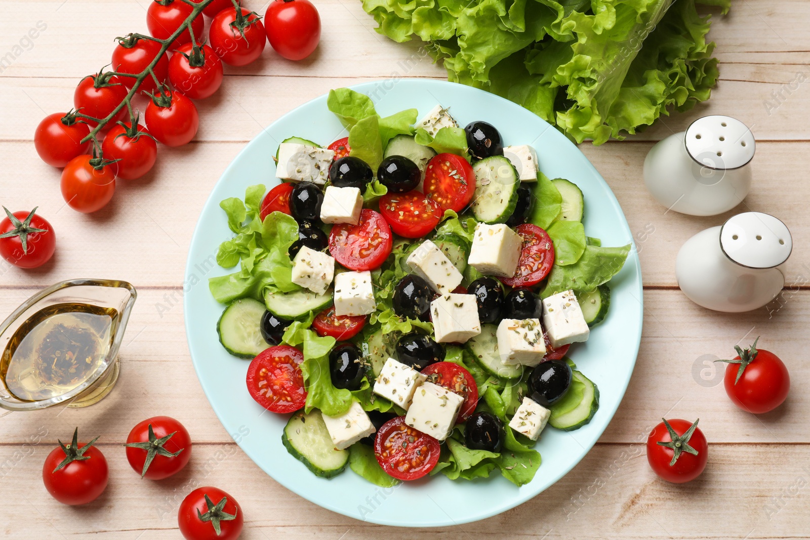 Photo of Delicious salad with feta cheese served on white wooden table, flat lay