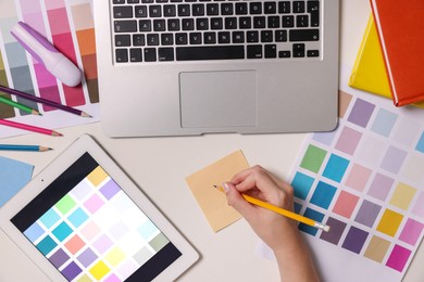 Photo of Website designer working at white table, top view