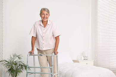 Photo of Senior woman with walking frame in hospital ward